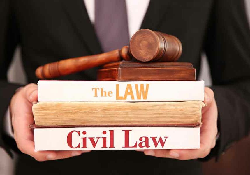 Lawyer holding Civil Law books and gavel
