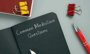 black book with "Common Mediation Questions" written at the top of the first page