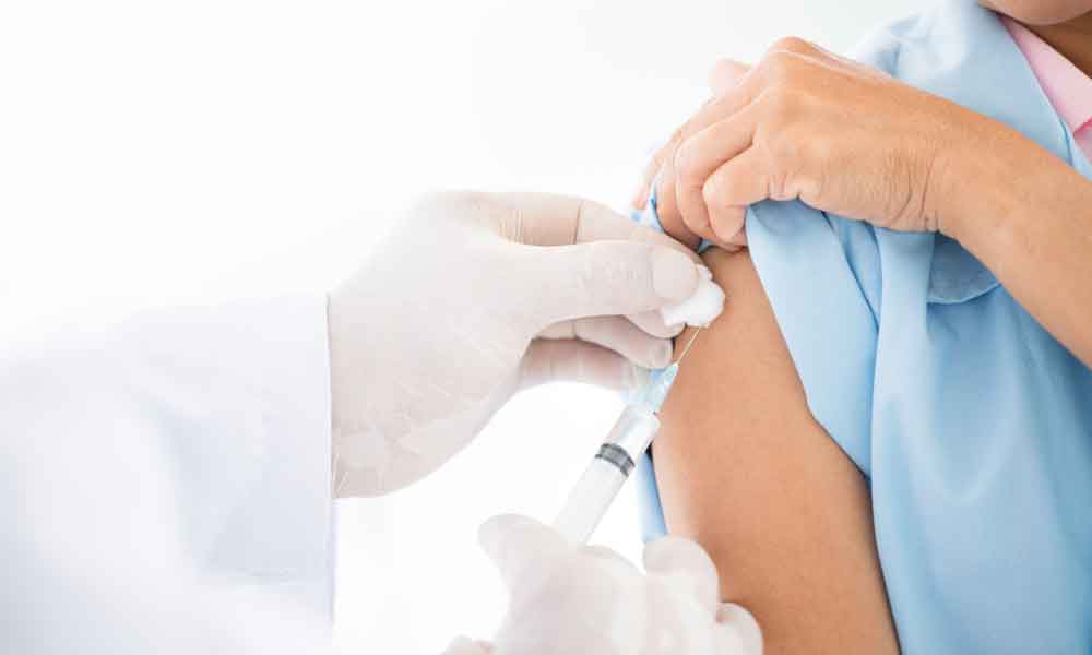 Medical professional finishing a vaccination for a patient.